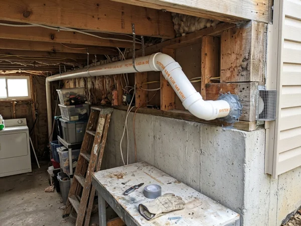 System 636 PVC venting run through the rim joist to the exterior